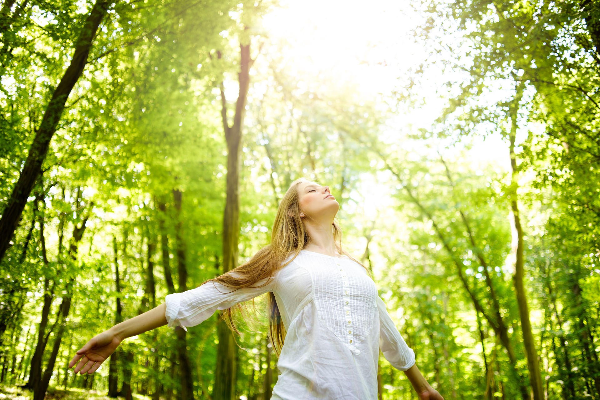 A women in the woods basking in the sun